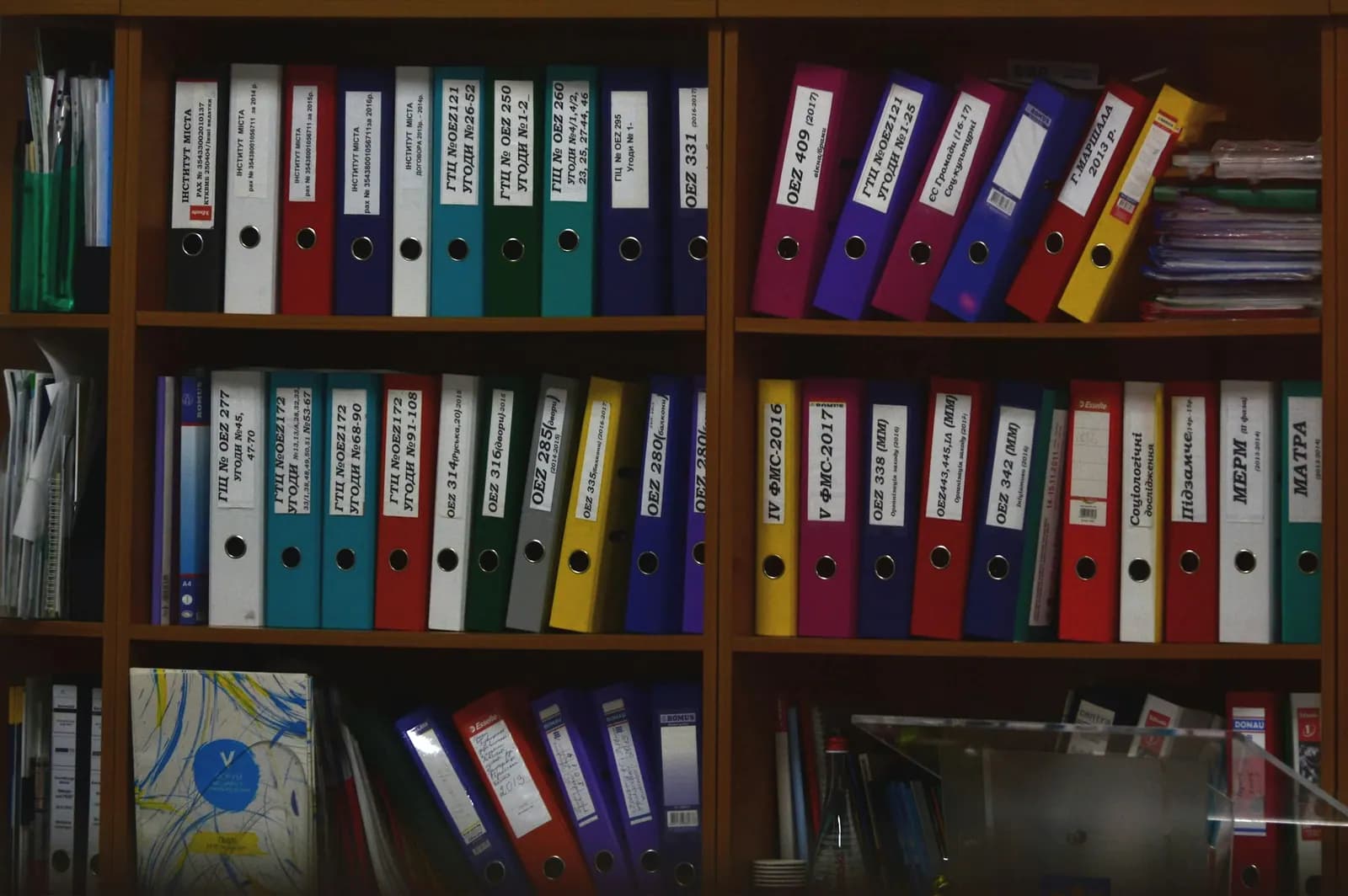Shelves of colourful ring binders